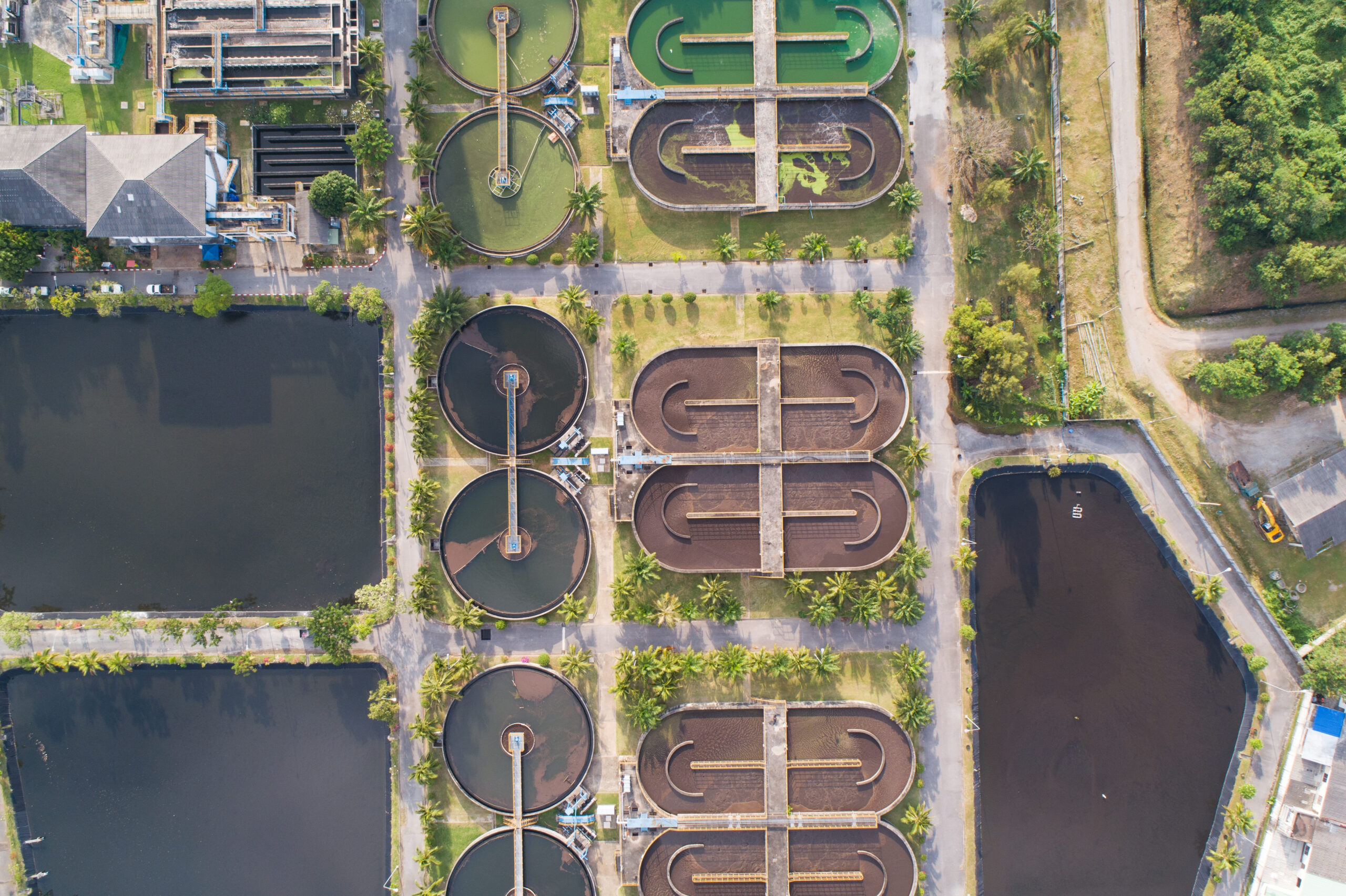 Aerial view High angle view Top down drone shot of the sewage treatment plant.The Solid contact clarifier tank type sludge recirculation in water treatment plant. Industrial wastewater treatment plant